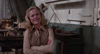 Movie still from “Hardcore” (1979), directed by Paul Schrader – A woman standing in front of a work bench; Medium shot, Low angle