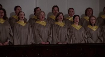 Movie still from “Hardcore” (1979), directed by Paul Schrader – A group of men and women singing in choir; Medium shot, Low angle