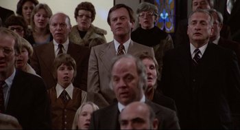 Movie still from “Hardcore” (1979), directed by Paul Schrader – A group of people standing in front of each other; Medium shot, High angle