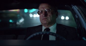 Movie still from “Hardcore” (1979), directed by Paul Schrader – A man in a suit and tie driving in a car; Close Up shot, Low angle