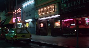 Movie still from “Hardcore” (1979), directed by Paul Schrader – A yellow taxi cab parked in front of a movie theater; Extreme Wide shot, Low angle