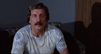 Movie still from “Hardcore” (1979), directed by Paul Schrader – A person sitting on a couch; Close Up shot, Low angle