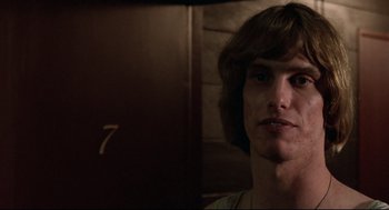 Movie still from “Hardcore” (1979), directed by Paul Schrader – A man with long brown hair is looking at the camera; Close Up shot, Low angle
