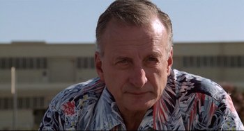 Movie still from “Hardcore” (1979), directed by Paul Schrader – A person wearing a hawaiian shirt; Close Up shot, Low angle
