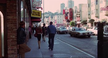 Movie still from “Hardcore” (1979), directed by Paul Schrader – A couple of people walking down a street; Wide shot, High angle