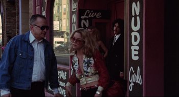 Movie still from “Hardcore” (1979), directed by Paul Schrader – A group of people standing in front of a building; Wide shot, Low angle