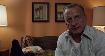 Movie still from “Hardcore” (1979), directed by Paul Schrader – An older man and a younger woman sitting on a bed; Medium shot, Low angle