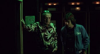Movie still from “Hardcore” (1979), directed by Paul Schrader – Two men standing next to each other in the dark; Medium shot, Low angle