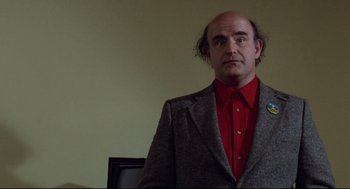 Movie still from “Hardcore” (1979), directed by Paul Schrader – A man in a red shirt and a gray suit jacket; Close Up shot, Low angle
