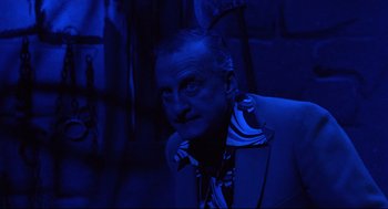 Movie still from “Hardcore” (1979), directed by Paul Schrader – A person wearing a suit and tie; Medium shot, Low angle