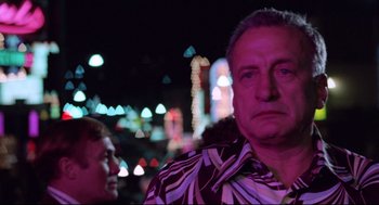 Movie still from “Hardcore” (1979), directed by Paul Schrader – A person wearing a hawaiian shirt; Close Up shot, Over the shoulder angle