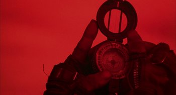 Movie still from “Hardware” (1990), directed by Richard Stanley – A person holding a compass in their hand; Extreme Close Up shot, Overhead angle