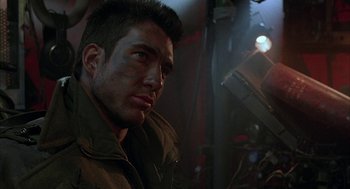 Movie still from “Hardware” (1990), directed by Richard Stanley – A person wearing a jacket; Close Up shot, Over the shoulder angle