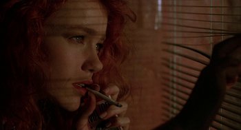 Movie still from “Hardware” (1990), directed by Richard Stanley – A person smoking a cigarette; Close Up shot, Low angle