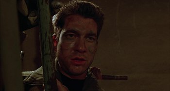 Movie still from “Hardware” (1990), directed by Richard Stanley – A person with a stick; Close Up shot, Low angle