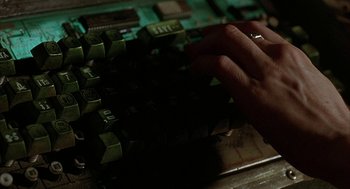 Movie still from “Hardware” (1990), directed by Richard Stanley – A person is typing on a computer keyboard; Extreme Close Up shot, Overhead angle
