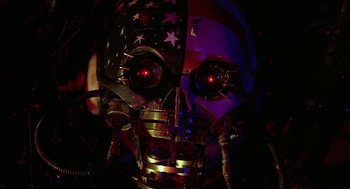 Movie still from “Hardware” (1990), directed by Richard Stanley – The face of an american robot; Close Up shot, Low angle