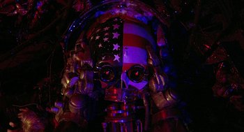 Movie still from “Hardware” (1990), directed by Richard Stanley – A skull that has been painted with the colors of the american flag; Close Up shot, Overhead angle