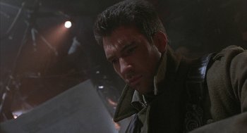 Movie still from “Hardware” (1990), directed by Richard Stanley – A person wearing a jacket; Close Up shot, Over the shoulder angle