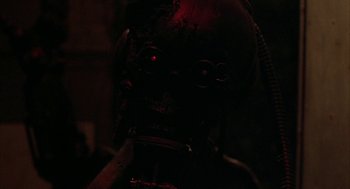 Movie still from “Hardware” (1990), directed by Richard Stanley – The face of an old robot; Close Up shot, Low angle