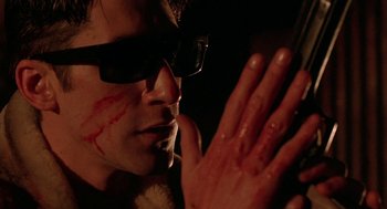 Movie still from “Hardware” (1990), directed by Richard Stanley – A person with blood all over his face; Extreme Close Up shot, Low angle