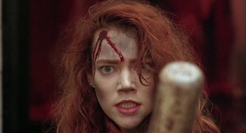 Movie still from “Hardware” (1990), directed by Richard Stanley – A person holding a baseball bat; Close Up shot, Low angle