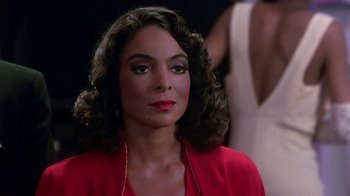 Movie still from “Harlem Nights” (1989), directed by Eddie Murphy – A person wearing a red shirt; Close Up shot, Over the shoulder angle
