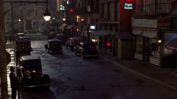 Movie still from “Harlem Nights” (1989), directed by Eddie Murphy – A street scene with a lot of cars on the road; Extreme Wide shot, High angle
