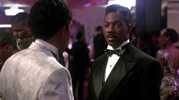 Movie still from “Harlem Nights” (1989), directed by Eddie Murphy – Two men in tuxedos talking to each other in a room; Close Up shot, Over the shoulder angle