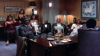Movie still from “Harlem Nights” (1989), directed by Eddie Murphy – A group of people sitting around a table; Wide shot, High angle