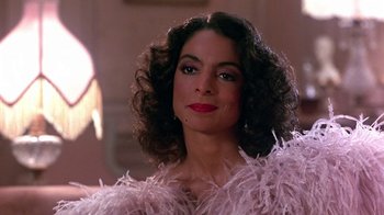 Movie still from “Harlem Nights” (1989), directed by Eddie Murphy – A person wearing a dress; Close Up shot, Over the shoulder angle