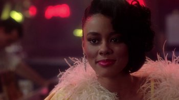 Movie still from “Harlem Nights” (1989), directed by Eddie Murphy – A person wearing a dress; Close Up shot, Low angle