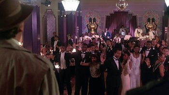 Movie still from “Harlem Nights” (1989), directed by Eddie Murphy – A group of people in formal wear holding candles; Wide shot, High angle