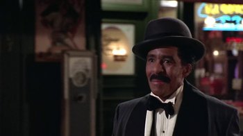 Movie still from “Harlem Nights” (1989), directed by Eddie Murphy – A man wearing a suit and a hat; Medium shot, Low angle