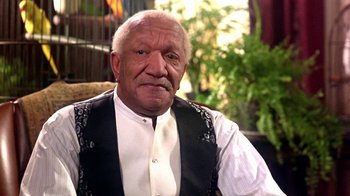 Movie still from “Harlem Nights” (1989), directed by Eddie Murphy – An older man wearing a black vest and a white shirt; Close Up shot, High angle