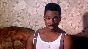 Movie still from “Harlem Nights” (1989), directed by Eddie Murphy – A person wearing a tank top; Close Up shot, High angle