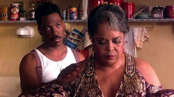 Movie still from “Harlem Nights” (1989), directed by Eddie Murphy – An older woman looking at a younger man; Close Up shot, Over the shoulder angle