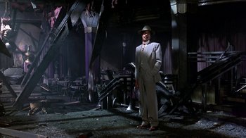 Movie still from “Harlem Nights” (1989), directed by Eddie Murphy – A man in a suit and a hat standing in a room; Wide shot, Low angle