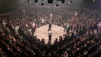 Movie still from “Harlem Nights” (1989), directed by Eddie Murphy – A crowd of people standing around a boxing ring; Extreme Wide shot, High angle