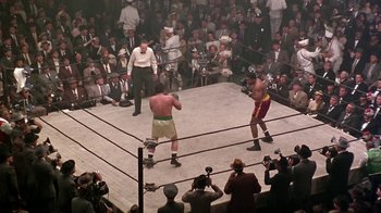 Movie still from “Harlem Nights” (1989), directed by Eddie Murphy – Two men are in a boxing ring in front of a crowd of onlookers; Extreme Wide shot, High angle