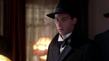 Movie still from “Harlem Nights” (1989), directed by Eddie Murphy – A man wearing a hat and a coat; Close Up shot, Low angle