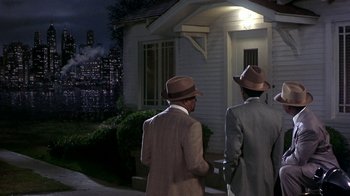 Movie still from “Harlem Nights” (1989), directed by Eddie Murphy – A couple of men standing next to each other outside; Wide shot, High angle