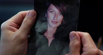 Movie still from “Harold & Kumar Go to White Castle” (2004), directed by Danny Leiner – A person holding a picture of a woman; Extreme Close Up shot, Overhead angle