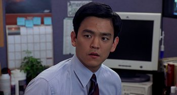 Movie still from “Harold & Kumar Go to White Castle” (2004), directed by Danny Leiner – A young man in a dress shirt and a tie; Close Up shot, Over the shoulder angle