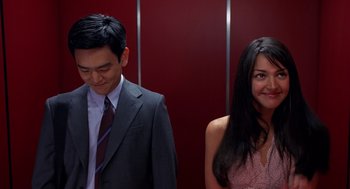Movie still from “Harold & Kumar Go to White Castle” (2004), directed by Danny Leiner – A man and a woman standing next to each other in an elevator; Medium shot, Over the shoulder angle