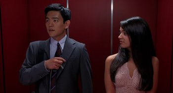 Movie still from “Harold & Kumar Go to White Castle” (2004), directed by Danny Leiner – A man and a woman standing next to each other in front of an elevator; Medium shot, Over the shoulder angle