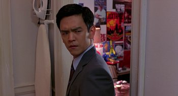Movie still from “Harold & Kumar Go to White Castle” (2004), directed by Danny Leiner – A man in a suit standing in front of a wall; Close Up shot, Over the shoulder angle