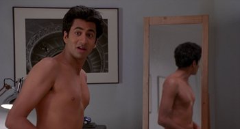 Movie still from “Harold & Kumar Go to White Castle” (2004), directed by Danny Leiner – A shirtless man in front of a bathroom mirror; Medium shot, Over the shoulder angle