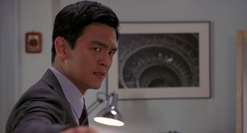 Movie still from “Harold & Kumar Go to White Castle” (2004), directed by Danny Leiner – A man in a suit and tie looking at the camera; Close Up shot, Over the shoulder angle