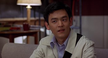 Movie still from “Harold & Kumar Go to White Castle” (2004), directed by Danny Leiner – A person sitting in a chair wearing a jacket; Close Up shot, Over the shoulder angle